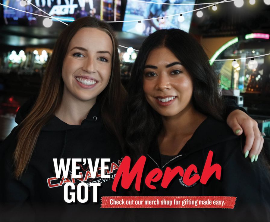 Two women smiling with their arms around each other wearing brewhouse merch. We've got merch - check out our merch shop for gifting made easy.