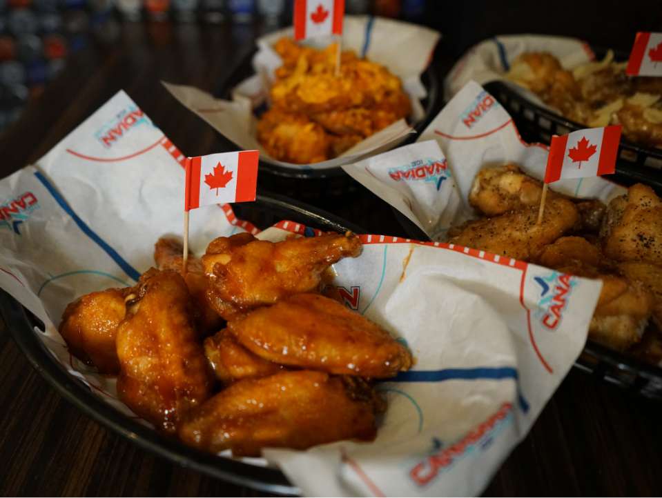 Multiple trays of wings posed for a photo